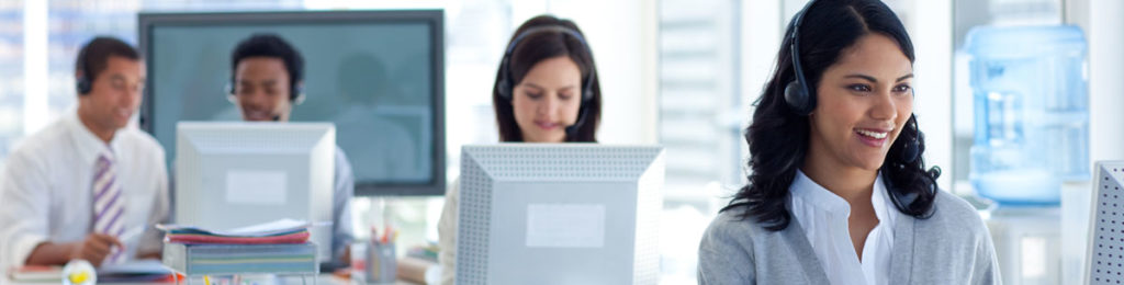 Four workers at a service call-center