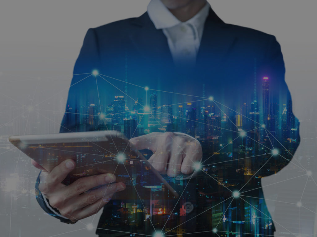 Man holding laptop with reflection of skyline