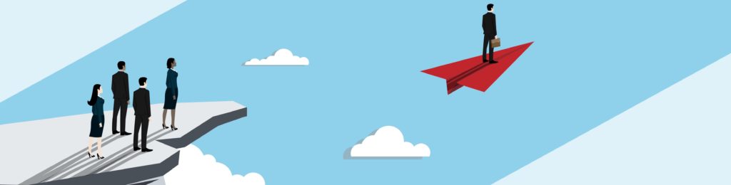 Four businesspeople watching one businessman soar away on a paper airplane.