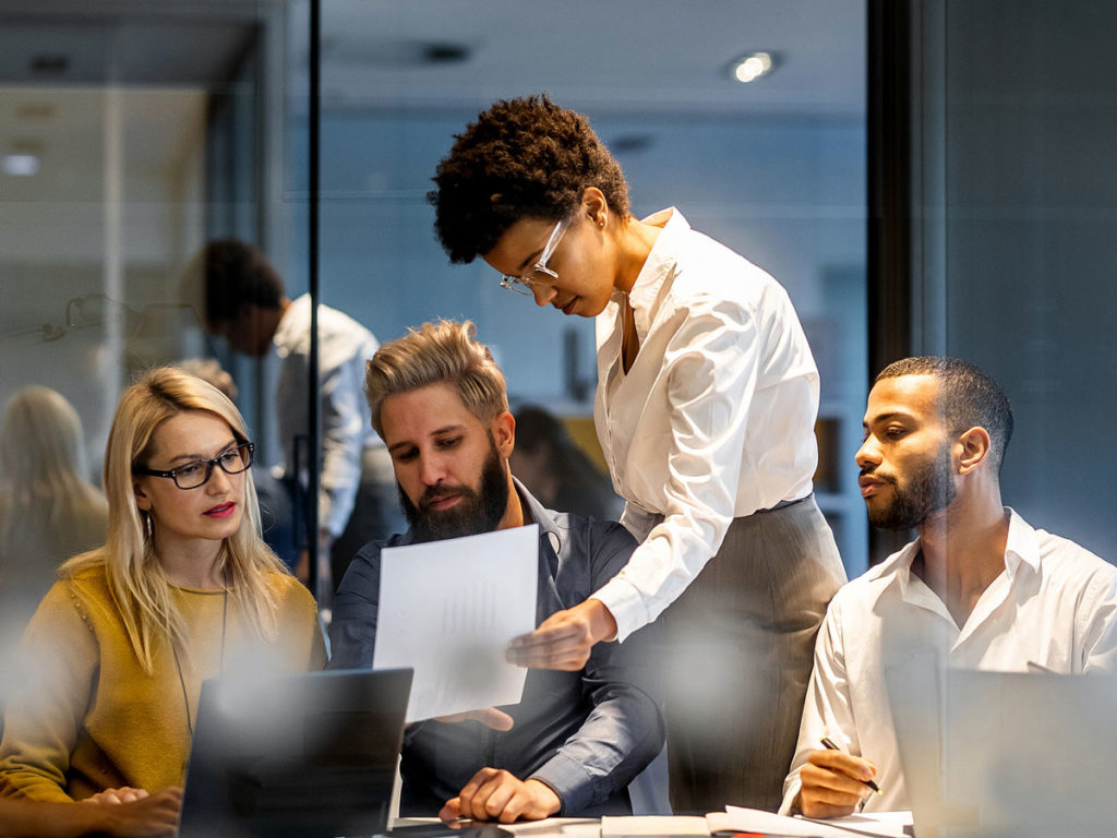 Four colleagues collaborating in an office