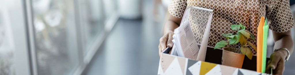 Person carrying box of things from their desk