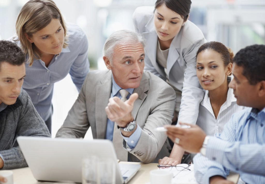 Business meeting - Senior manager discussing work with his colleagues