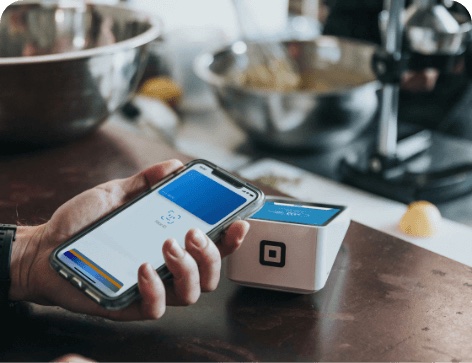 Person holding phone using Apple Pay