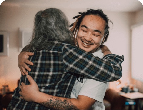 two people hugging and smiling