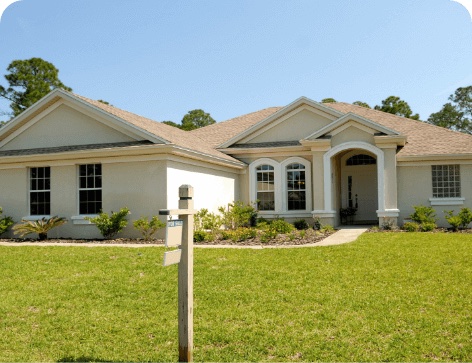 Home with a real estate sign in front