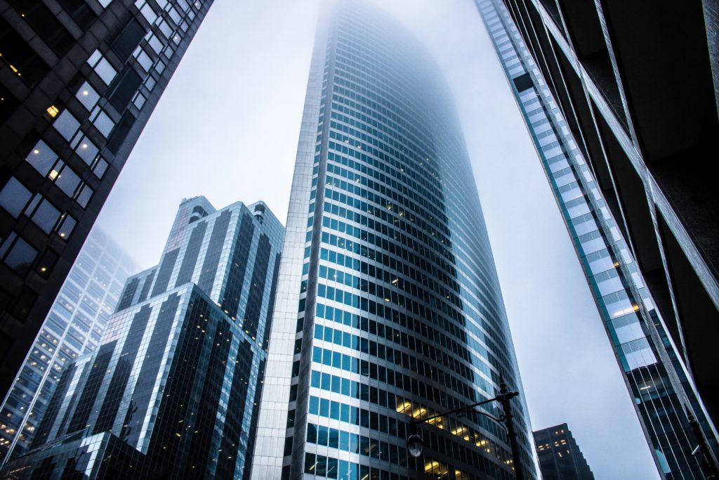 Upward view of tall buildings.