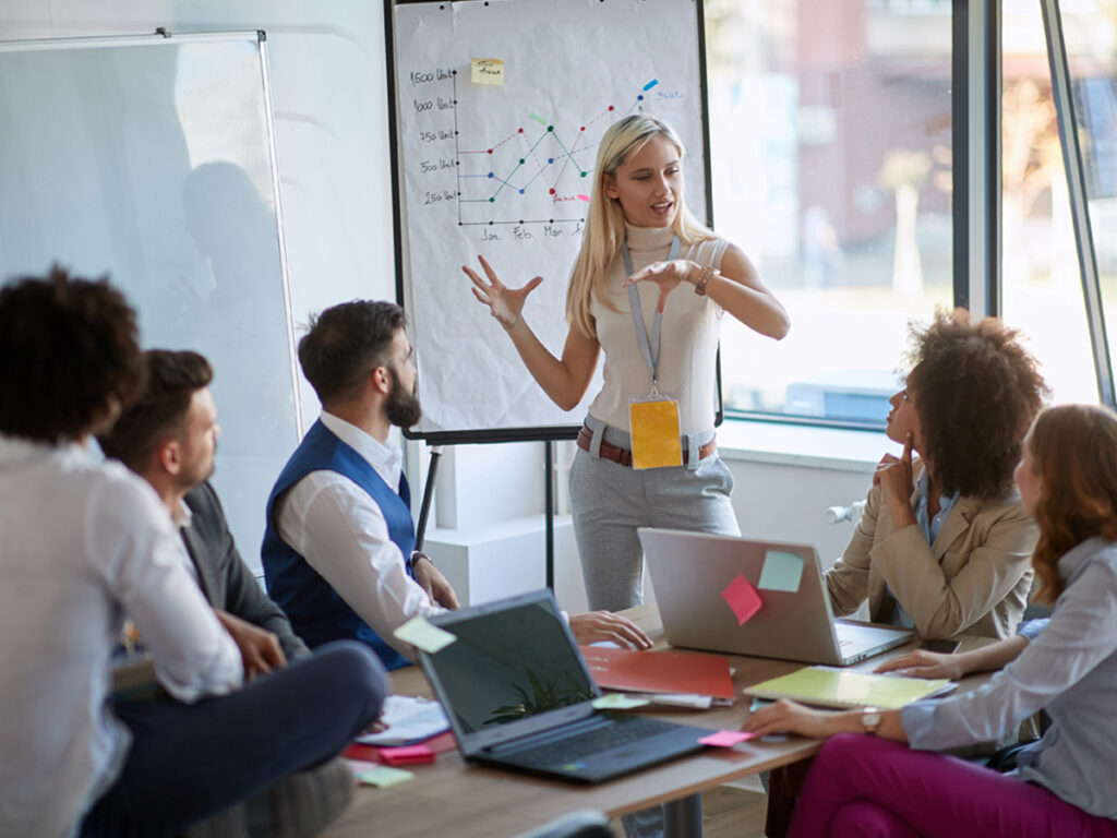 presenter giving an explanation in a small office meeting