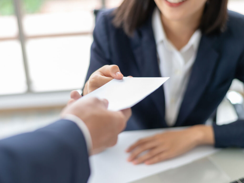 worker being handed an envelope