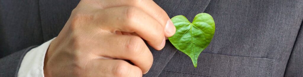 hand holding a heart shaped leaf