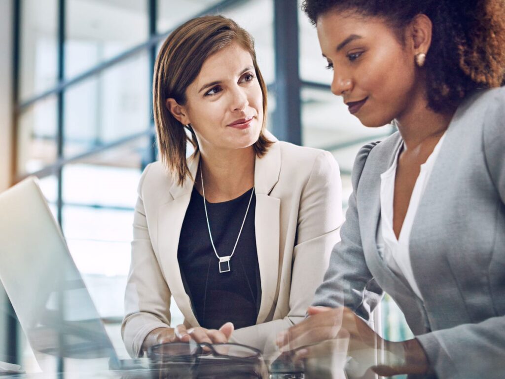 two business women working together on a laptop